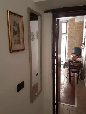 a mirror hanging on a wall next to a hallway at Tiny House in Palermo