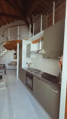 a kitchen with stainless steel cabinets and a stove at I Tamarindi in Palermo