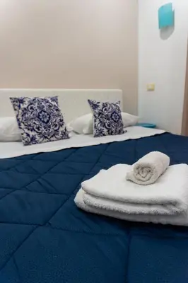 two beds with towels sitting on top of them at QuattroCantiApartment2 Palermo in Palermo