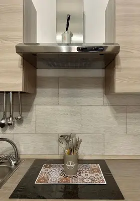 a kitchen counter with a sink and a cup with utensils at Casetta Bedda in Palermo