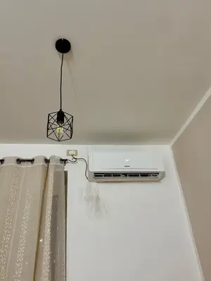 a light hanging from a ceiling with a curtain at Casetta Bedda in Palermo