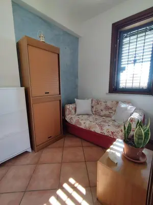 a living room with a couch and a window at Casa Maria Elena in Santa Flavia