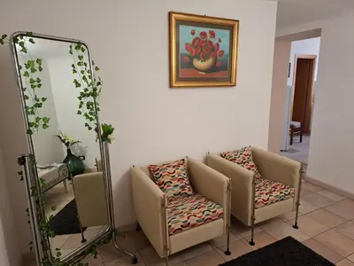 a room with two chairs and a mirror at Vucciria room in Palermo