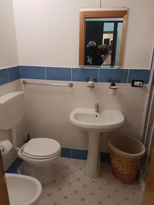 a bathroom with a toilet and a sink at Vucciria room in Palermo