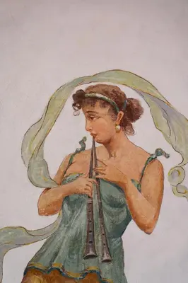a painting of a woman in a green dress holding an object at Casamusa suite in Palermo