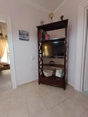 a living room with a flat screen tv on a shelf at Trip Rooms 2 in Palermo
