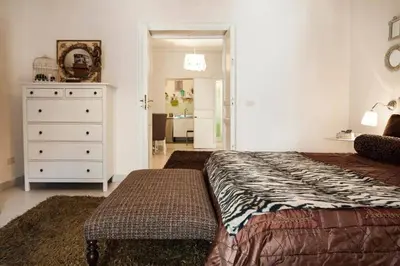 a bedroom with a bed and a dresser and a room at Trip Rooms 2 in Palermo