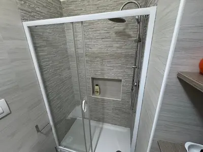 a shower with a glass door in a bathroom at La Dolcissima in Castellammare del Golfo
