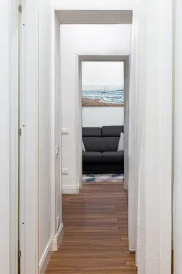 a hallway with a view of the ocean through two doors at 105 Apartments in Palermo