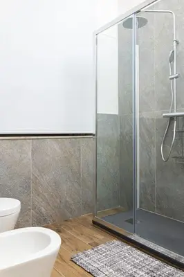 a bathroom with a shower and a toilet and a sink at 105 Apartments in Palermo