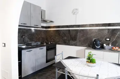 a kitchen with a table and a stove top oven at Cuor di Leone in Corleone