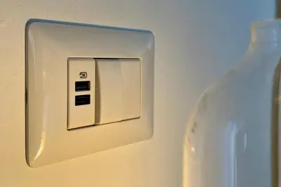 a light switch on a wall with a bottle at La Cala Holiday Flat in Palermo