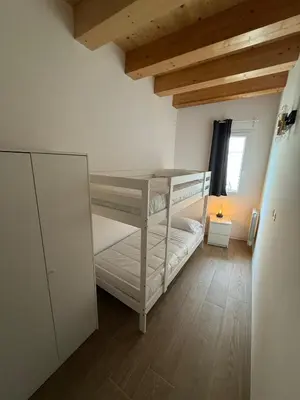 a bedroom with two bunk beds and a window at La Cala Holiday Flat in Palermo