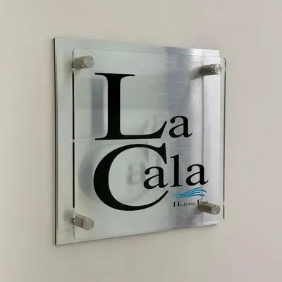 a sign on a wall that says la ash at La Cala Holiday Flat in Palermo