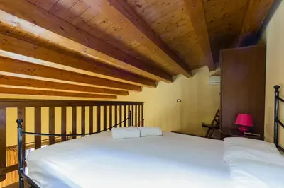 a bedroom with a bed with a wooden ceiling at Visitsicilia Le Magnolie in Castellammare del Golfo