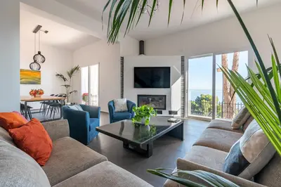 a living room with a couch and a table at Villa con accesso al mare e vista mozzafiato in Palermo