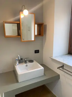 a bathroom with a white sink and a mirror at La Casetta al Mercato del Capo in Palermo