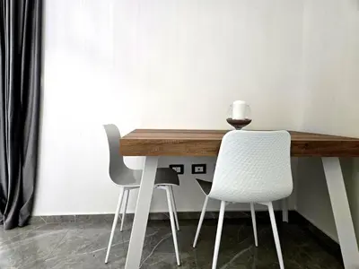 a table with two chairs and a vase on top of it at Vicoletto Natalia - Proppro SRL- Palermo in Palermo