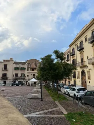 a parking lot with cars parked in front of buildings at Vicoletto Natalia - Proppro SRL- Palermo in Palermo