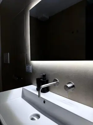 a bathroom with a sink and a mirror at Santa Rosalia Suites in Palermo