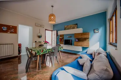 a blue living room with a blue couch and a table at Casa Vacanze Verdemare in Mondello