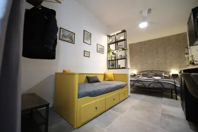 a bedroom with a yellow bed in a room at T&F Casa al Capo - In centro a Palermo in Palermo
