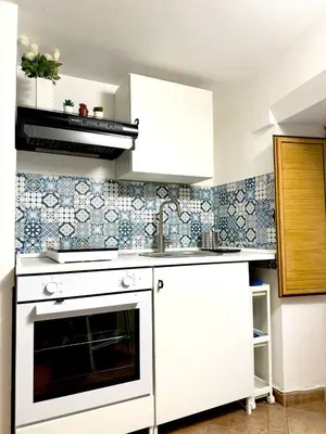 a kitchen with a white stove and a sink at Nova Holidays in Palermo