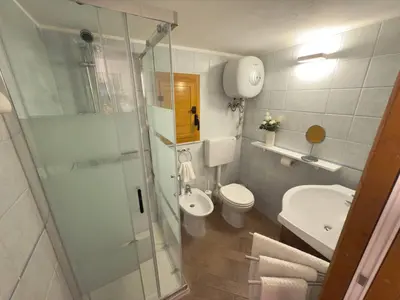 a bathroom with a shower and a toilet and a sink at Nova Holidays in Palermo