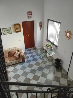 a living room with a glass table and a checkered floor at Vernagallo's House 2 in Palermo