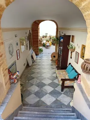 an archway leading up to a house with a tile floor at Vernagallo's House 2 in Palermo