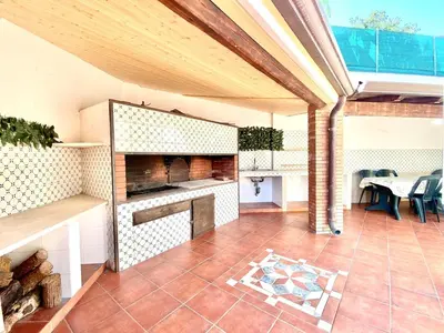 an outdoor patio with a fireplace and a table at Villa Grace, beach 200 meters away, independent in Alcamo