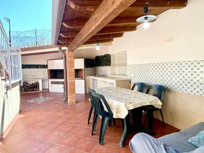 a kitchen and dining room with a table and chairs at Villa Grace, beach 200 meters away, independent in Alcamo