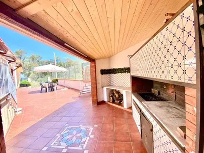 an outdoor kitchen with a patio with a table at Villa Grace, beach 200 meters away, independent in Alcamo