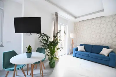 a living room with a blue couch and a table at iFlat Casa Diamante in Palermo