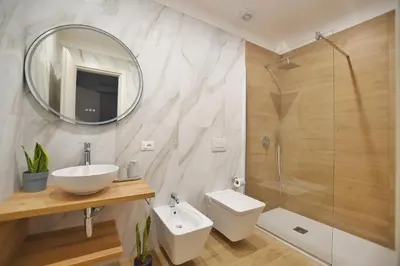 a bathroom with a sink and a toilet and a mirror at iFlat Casa Diamante in Palermo