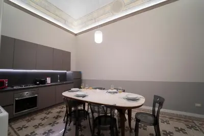a kitchen with a table and chairs in a room at Il Tesoretto 1 in Palermo