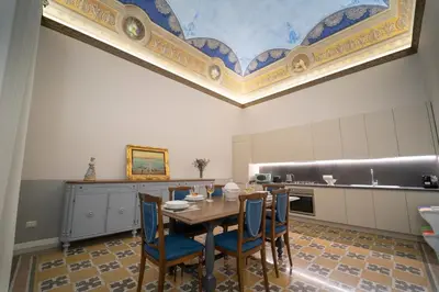 a kitchen with a table and chairs and a ceiling at Il Tesoretto 2 in Palermo