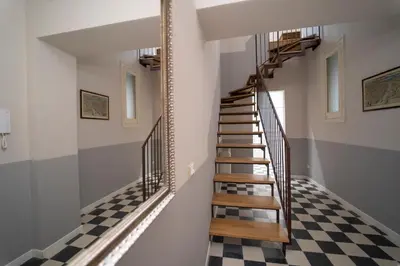 a staircase in a house with a checkered floor at Il Tesoretto 2 in Palermo