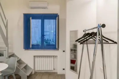 a room with a staircase and a window at La Terza Porta in Palermo