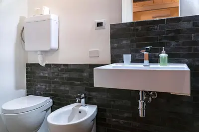a bathroom with a white sink and a toilet at La Terza Porta in Palermo