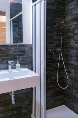 a bathroom with a sink and a shower at La Terza Porta in Palermo