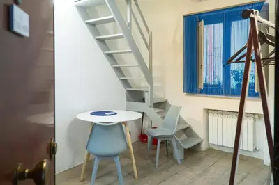 a staircase in a room with chairs and a table at La Terza Porta in Palermo