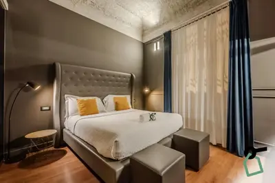 a bedroom with a large bed and a large window at HOTIDAY Palermo Palco Noir in Palermo