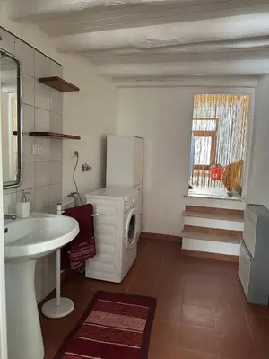 a bathroom with a sink and a washing machine at Soraya House Next quattrocanti in Palermo