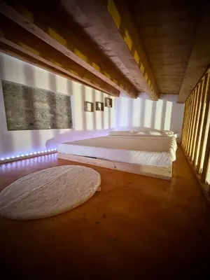 a bedroom with two beds and two rugs on the floor at Il carrettiere in Termini Imerese
