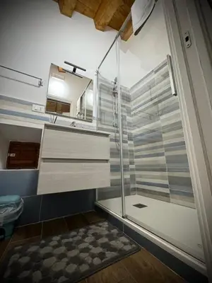 a bathroom with a shower with a glass door at Il carrettiere in Termini Imerese