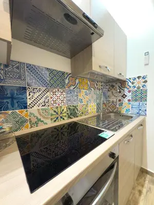 a kitchen with colorful tiles on the wall at My Life in Palermo