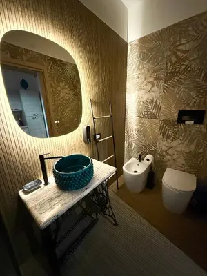 a bathroom with a sink and a mirror and a toilet at My Life in Palermo