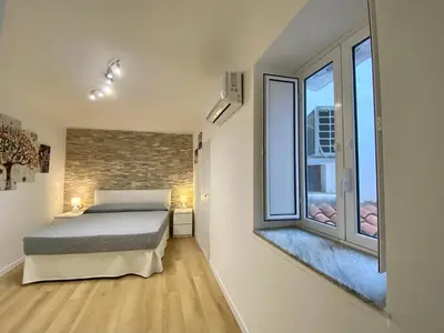 a bedroom with a bed and two large windows at A Casa di Jimmy in Palermo