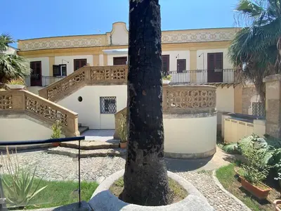 an entrance to a building with an open door at Apartment in Villa Storica Lanterna sul Mare Palermo in Palermo